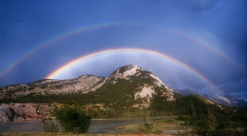 double rainbow over mountain